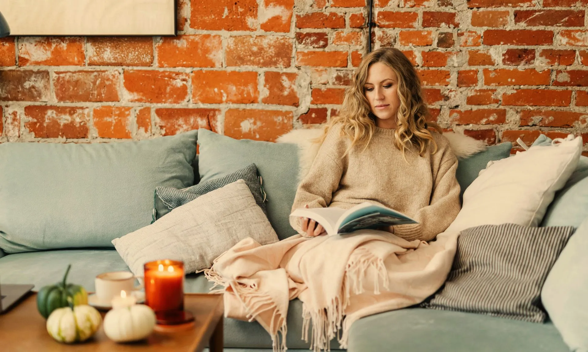 a girl sitting in her living room decorated with fall decor ideas