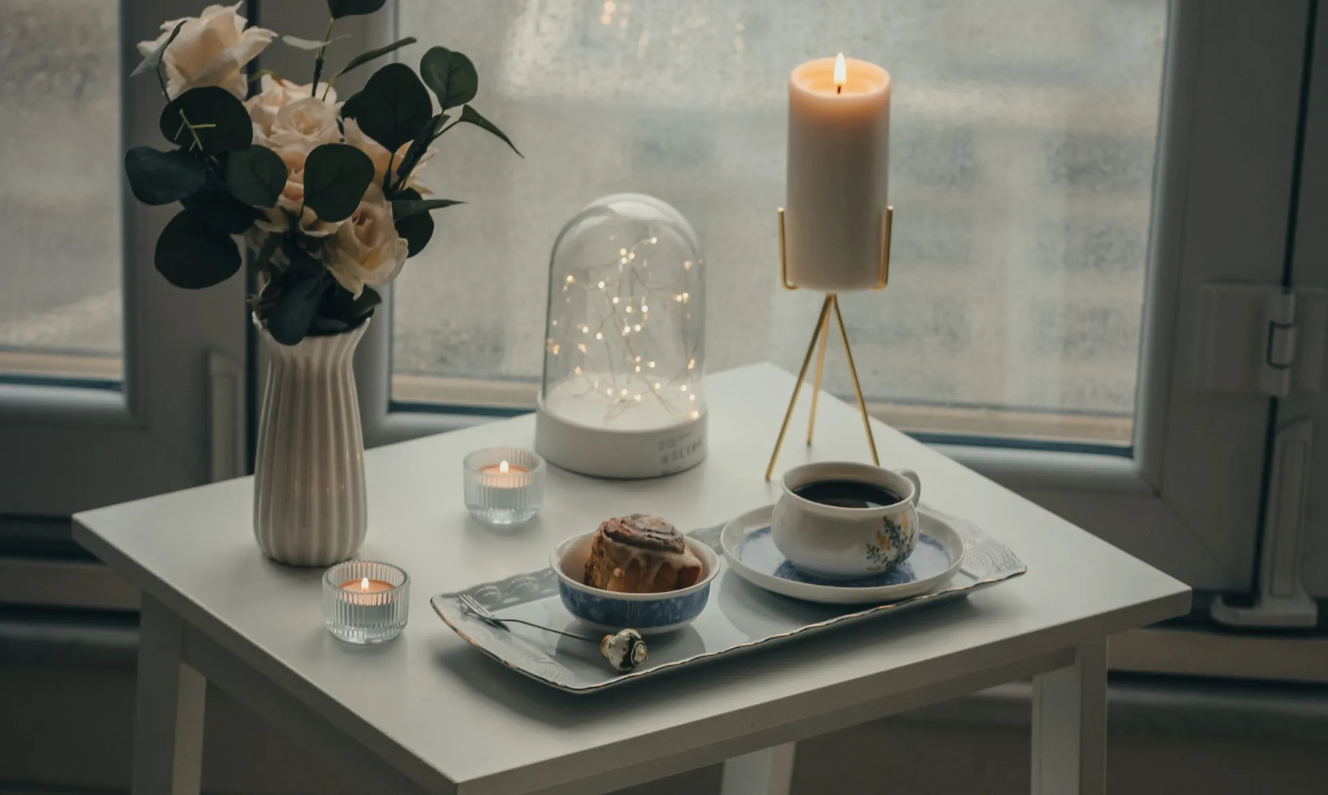 DIY home decor ideas for beginners featuring a beautifully styled coffee table with candles, flowers, and a decorative tray for a cozy living room