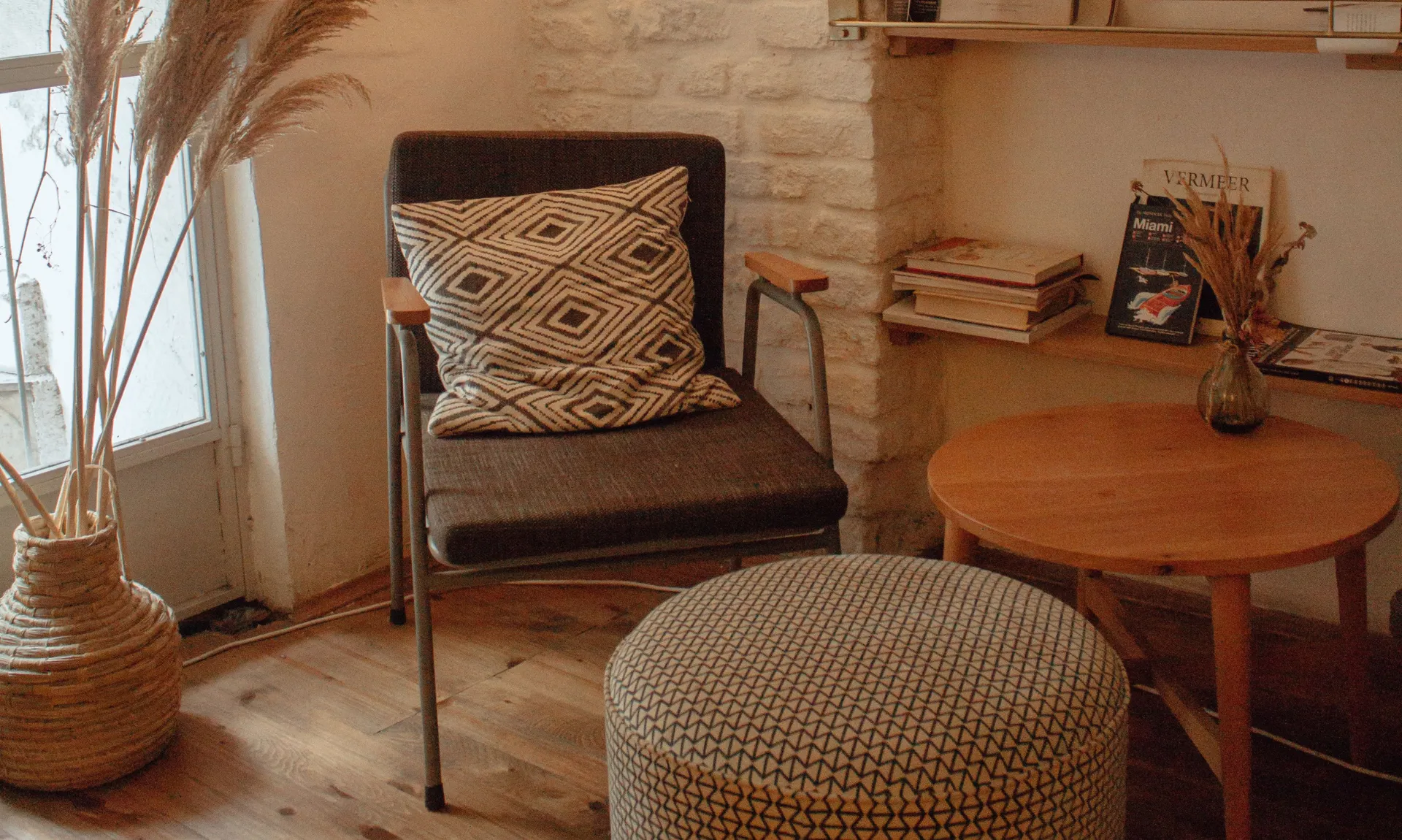 DIY home decor ideas for beginners featuring a cozy reading corner with an accent chair, side table, books, and natural decor accents