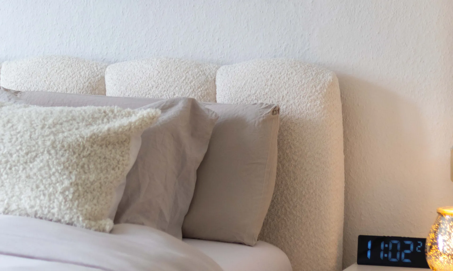 DIY home decor ideas for beginners featuring a cozy upholstered headboard with neutral bedding for an elegant and budget-friendly bedroom makeover