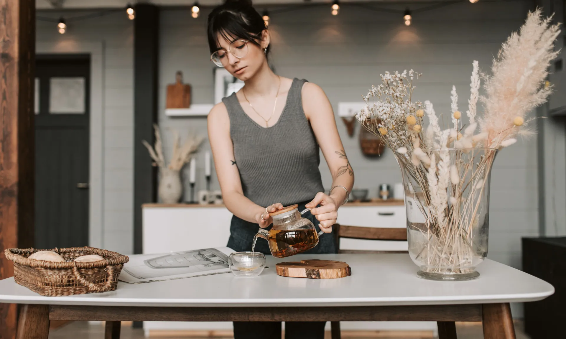 A girl having tea in the kitchen with subtle hints of a timeless kitchen in the background