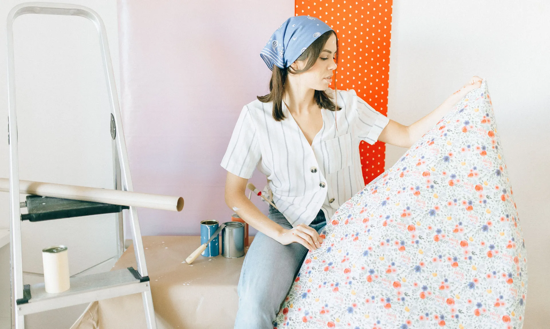 a girl with peel-and-stick wallpaper working on DIY project
