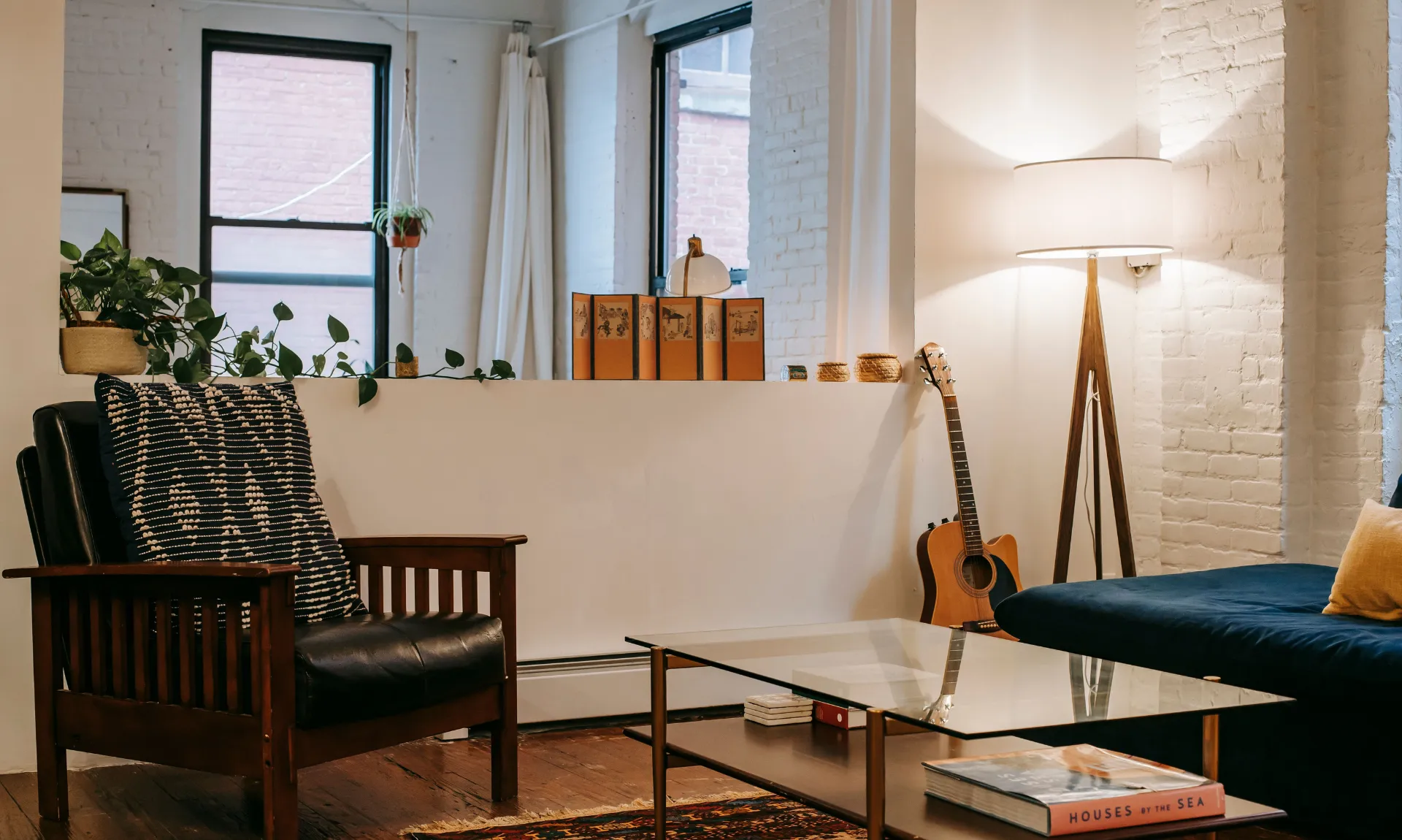 a living room with mismatched furniture pieces that represent the beauty of everyday life